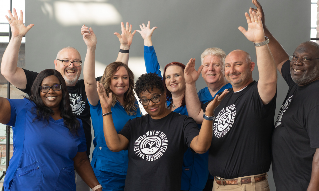 Leadership Circle group laughing and raising their hands