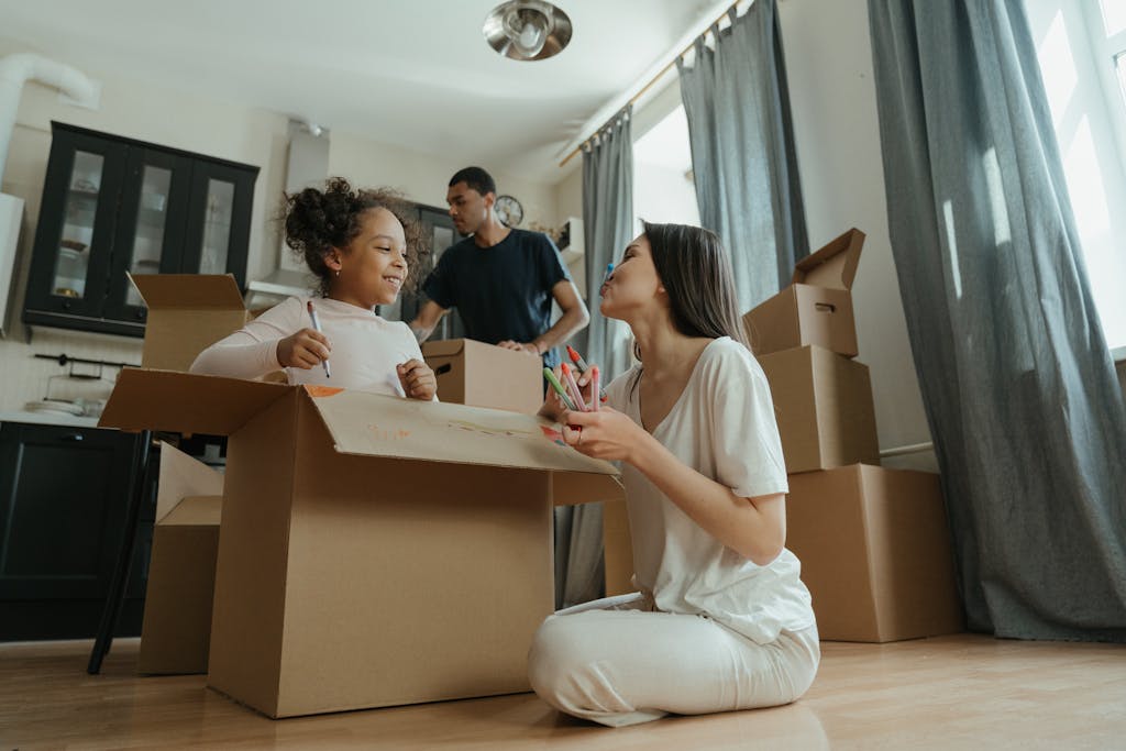 A joyful family unpacking boxes while moving into their new home.